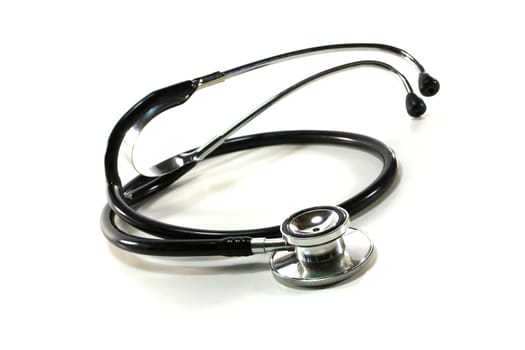 silver and black stethoscope on white background