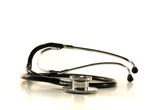 silver and black stethoscope on white background