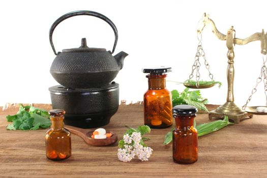 Pharmacists scale with Tea kettle, apothecary bottles and fresh herbs