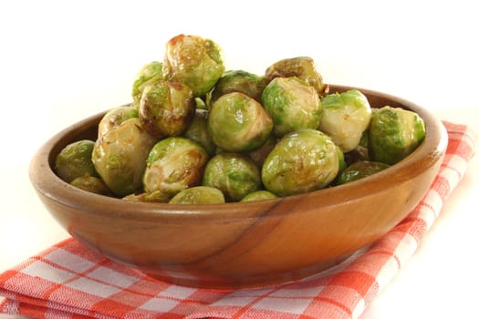 roasted brussels sprouts in a wooden bowl on a checkered napkin