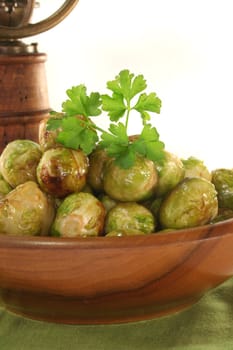 roasted brussels sprouts in a wooden bowl on a green napkin