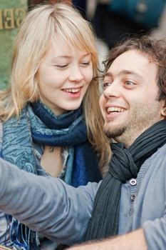 Happy young couple sitting on the terrace of a restaurant in Paris