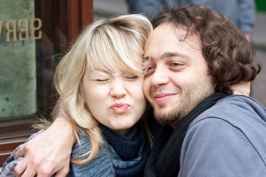 Happy young couple in love sitting on the terrace of a restaurant in Paris