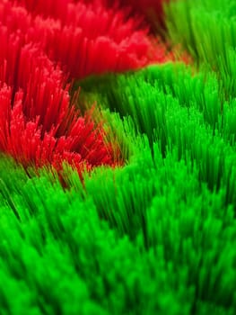 Macro of red and green cleaning brushes