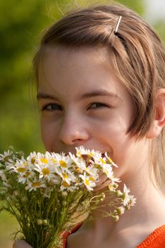 Teen girl with a bouquet of the wild flowers