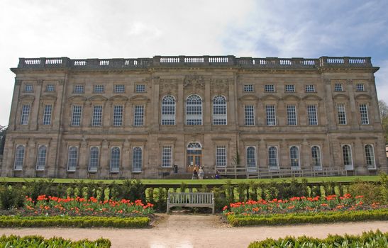 Frontage of an Eighteenth Century Stately home and lawns under a blue sky