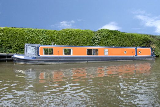 An Orange Narrowboat on the Leeds Liverpool Canal at Skipton Yorkshire