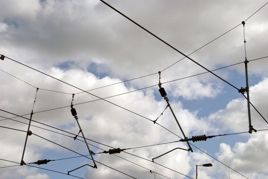 The overhead power cables of aa railway line in Yorkshire England against a blue sky