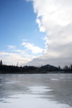 Cloudy skies over the deserted winter lake
