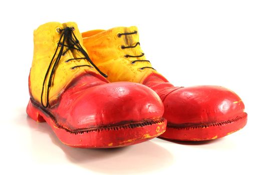 red and yellow clown shoes on a white background