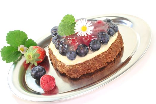 heart-shaped wild berry tart with berries, lemon balm and Daisy