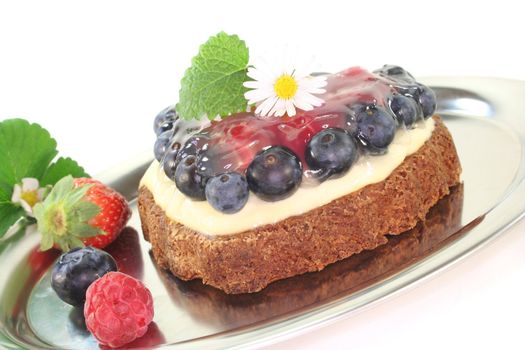 heart-shaped wild berry tart with berries, lemon balm and Daisy