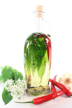 one bottle of Wild garlic oil with leaves and flowers on a white background