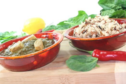 Indian Palak Paneer with mixed rice, ginger and Asian spices on white background