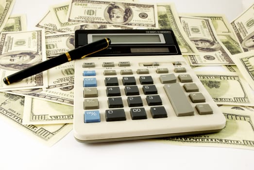 calculator, pen  and paper money on a white background