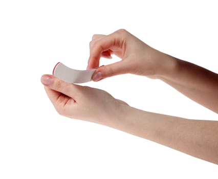 Manicure. Hands with the nail file on the white background
