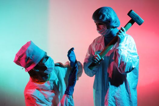 Doctors with a sledgehammer on a abstract dirty colored background
