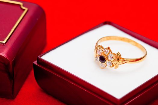 Fantastic gold ring adorned with one blue  and several white zirconia