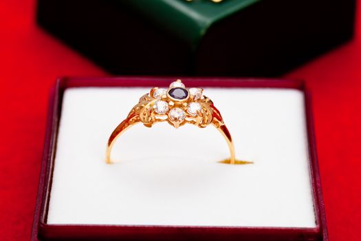 Fantastic gold ring adorned with one blue  and several white zirconia