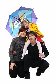 Grandfather and grandmother holding her granddaughter in her arms under an umbrella on tne white background