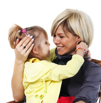 little girl hugs the young mother on the white background
