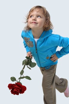 Little girl with a red rose on the grey background
