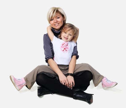 little girl hugs the young mother on the white background
