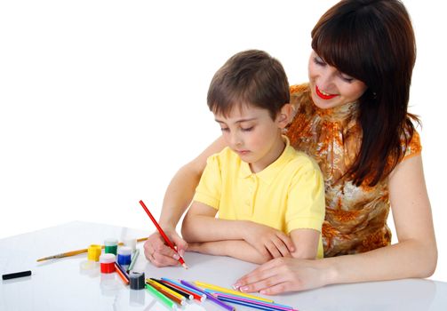 small boy and a young girl with colored pencils on the white background
