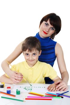 small boy and a young girl with colored pencils on the white background
