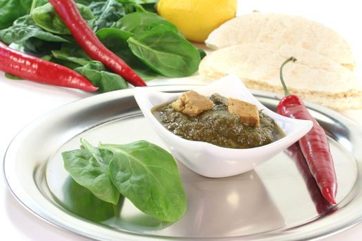 Indian Palak Paneer with mixed rice, ginger and Asian spices on white background