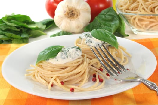 Noodle nests with cheese-spinach sauce and fresh basil