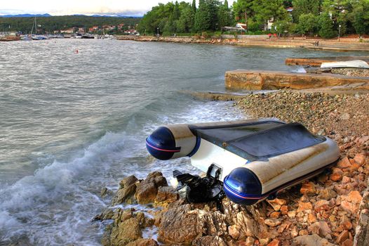 Boat crashed on the rocks sea shore after strong storm, Malinska, croatia