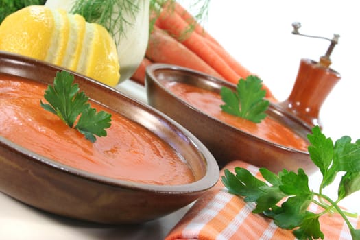 a bowl of carrot soup with fresh parsley