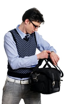 young man with a bag of looking at the watch on the white background
