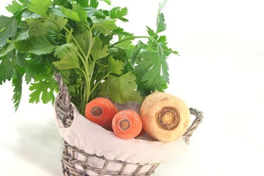 Greens with carrots, leek, parsley and parsley root in the basket