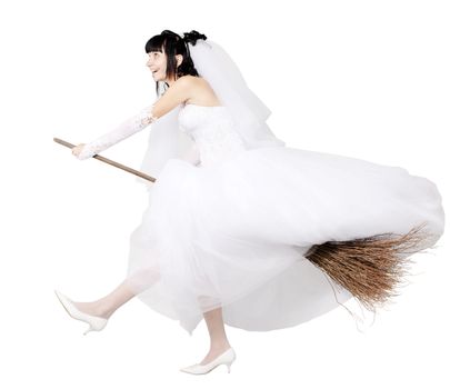 bride in white wedding dress on a broom
