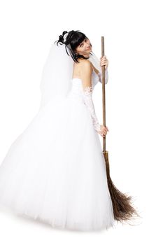 bride in white wedding dress on a broom
