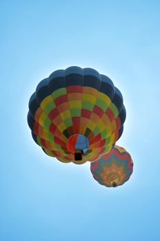 Two hot air balloons floating and flying up high