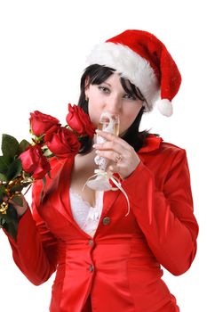 Portrait of a beautiful young woman in a red suit and hat of Santa Claus with red roses and champagne on the white background
