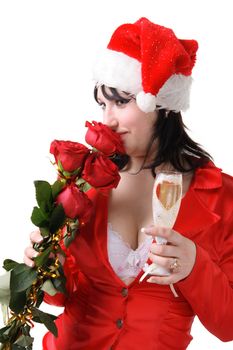 Portrait of a beautiful young woman in a red suit and hat of Santa Claus with red roses and champagne on the white background
