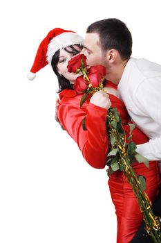 young boy hugs and kisses the girl of Santa Claus on the white background
