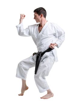 Karate. Man in a kimono with a white background
