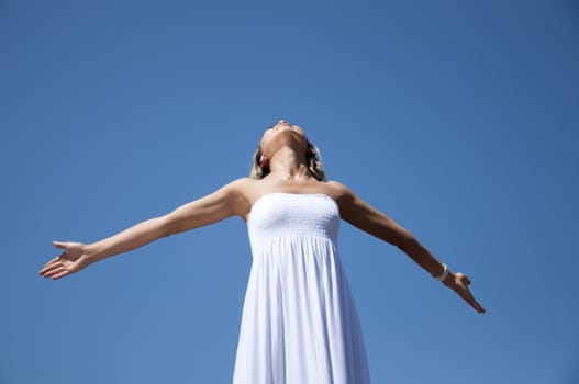 portrait young woman having stretched hands aspires in the sky