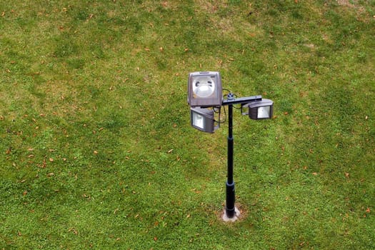 Powerful lighting lantern against green grass background