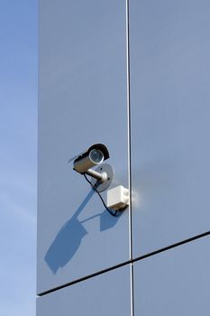 A security camera on the side of an office building.