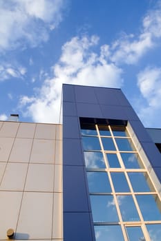 Modern office building facade against blue sky.