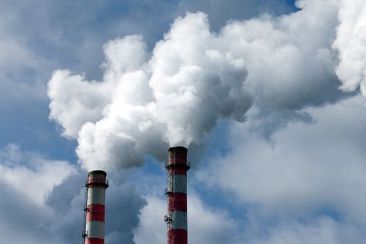 Smoke coming out of an industrial pipes