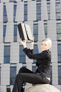 sitting young businesswoman with a briefcase