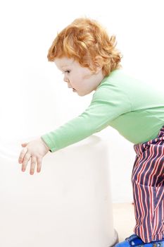 standing little boy with a toy