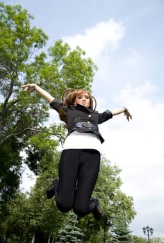 young girl jumping in park